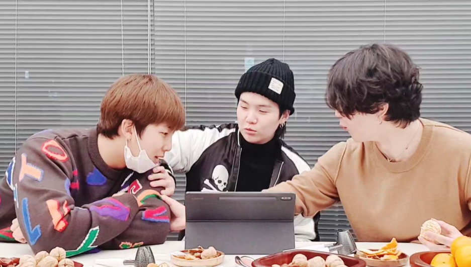 Namjoon, Yoongi and Jimin checking out what's going on their tablet during a Weverse Live session. 