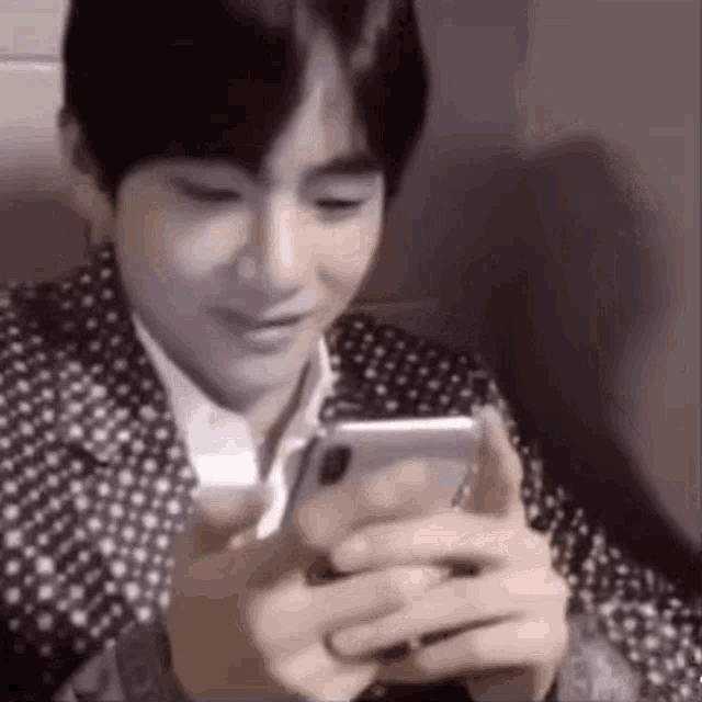 GIF:  Tae is excited about whatever is on his phone!